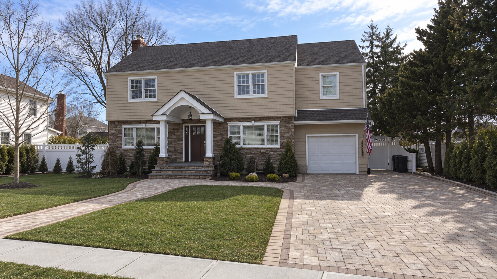 Shake-sided colonial on Long Island with stone entry, new roof, and paver driveway